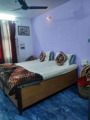 a bedroom with a bed with pillows on it at Hotel Ashu , Ntl Road in Haldwāni