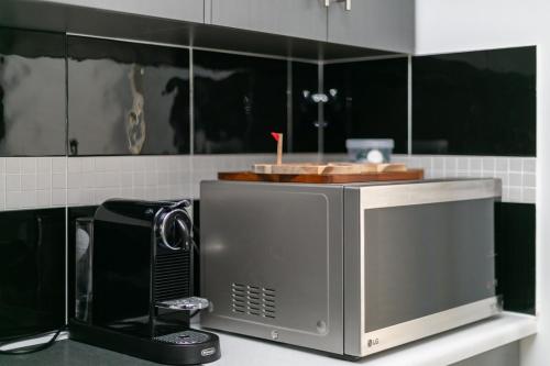 a microwave on a counter in a kitchen at 19th Hole Golf, Wine & Sea in Normanville