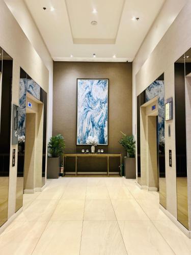 a hallway of a building with a painting on the wall at Nico's Studio Condo in Cebu City