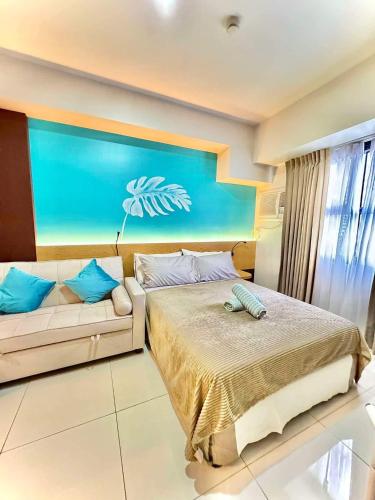 a bedroom with a bed and a couch at Nico's Studio Condo in Cebu City