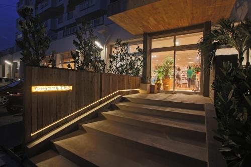 a staircase leading to a building at night at Guest House Chura Cucule Ishigakijima in Ishigaki Island