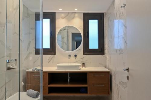 a bathroom with a sink and a shower at Serenity Residence in Neoi Epivates