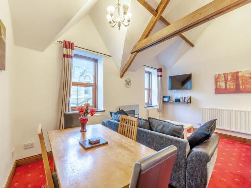 a living room with a couch and a table at The Old Drapery - Uk43568 in Haltwhistle