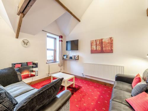 a living room with two couches and a tv at The Old Drapery - Uk43568 in Haltwhistle