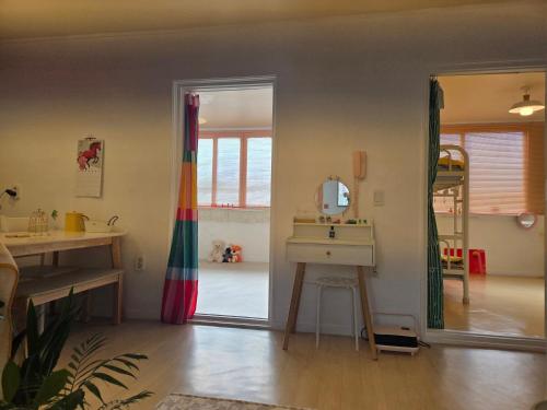 a bathroom with a mirror and a sink in a room at 케이앞산 하우스 in Daegu