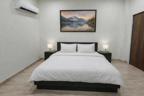 a bedroom with a large bed with two night stands at BODHI Residency in Greater Noida