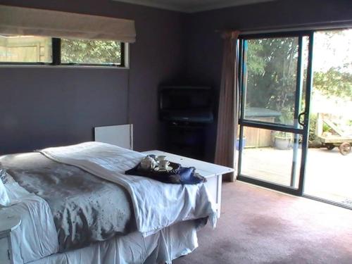 a bedroom with a bed with a teddy bear on it at Miranda Sea View Apartment in Miranda