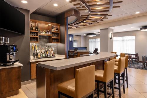 a bar in a restaurant with chairs and a counter at Hyatt Place Sterling Dulles Airport North in Sterling