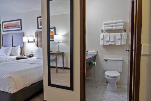 a hotel room with a bed and a toilet at Quality Inn Milan-Sandusky in Milan