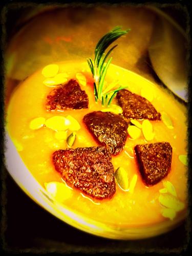 a yellow plate of soup with four pieces of meat at Baita La Jolie Bergere in La Salle
