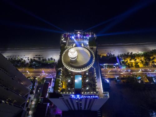 a tall building with lights on it at night at Havana Nha Trang Hotel in Nha Trang