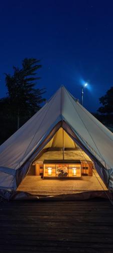 a white tent with lights in it at night at ILLU Glamping in Trebujeni