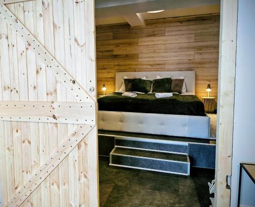 a bedroom with a bed and a wooden wall at INsight - workcation oldtown in Ingolstadt