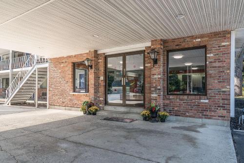 a brick building with flowers in front of it at MOTEL 6 - Albany, NY - Airport in Albany