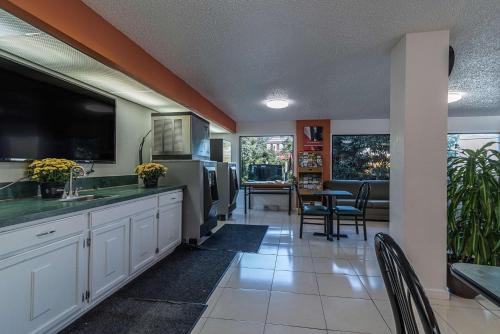 a kitchen with a sink and a table with chairs at MOTEL 6 - Albany, NY - Airport in Albany
