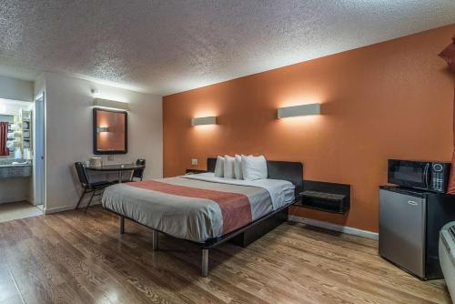 a hotel room with a bed and a desk at MOTEL 6 - Albany, NY - Airport in Albany