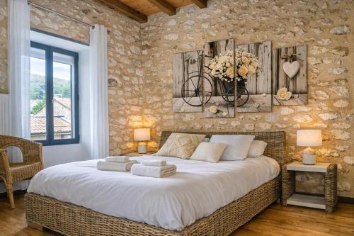 a bedroom with a large bed in a room at La Colline Truffière in Sourzac