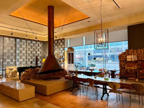 a restaurant with a large fireplace and tables and chairs at BREEV GWANGJU by LOTTE HOTELS, formerly Ramada Plaza by Wyndham Gwangju in Gwangju