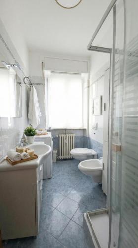 a bathroom with two sinks and two toilets and a shower at Apartment with a Mountain View in Lecco