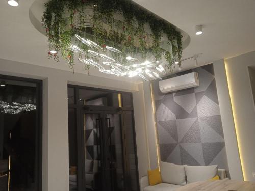 a bedroom with a bed and a ceiling with plants at NINETY boutique hotel in Yakkasaray