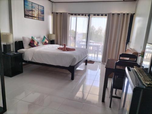 a bedroom with a bed with a teddy bear on it at Baan Seaview Sunset in Ko Lanta