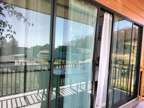 a glass balcony with a glass table on it at Baan Seaview Sunset in Ko Lanta