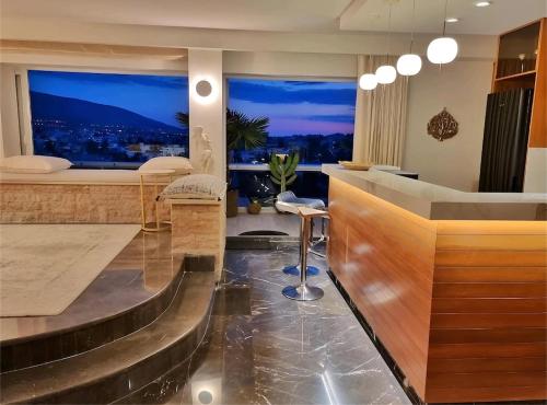a bar with a view of a city at night at One 360 Skyline Athens Penthouses in Athens
