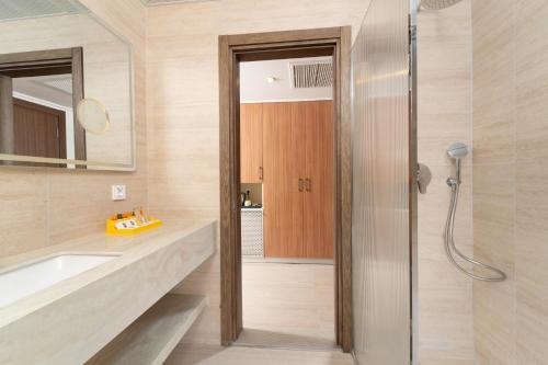 a bathroom with a sink and a shower at Sundia By Liberty Suncity in Oludeniz