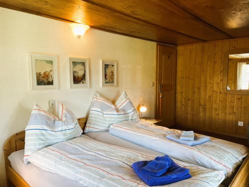 a bedroom with two beds with towels on them at BnB Haus Itten in Hondrich