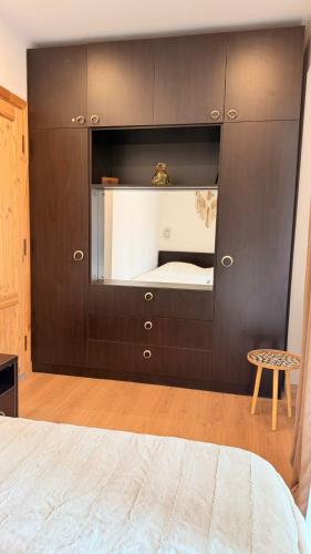 a bedroom with a black cabinet with a mirror at Bakuriani valley Didveli in Bakuriani