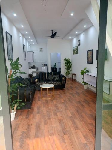 a living room with couches and a table at BIA RESIDENCEs in Sāhīwāl
