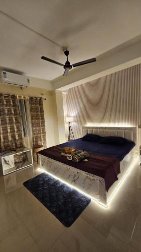 a bedroom with a large bed with a light on it at OhanaStay02 in Guwahati
