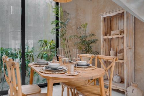 a dining room with a wooden table and chairs at South Villa Ungasan in Ungasan