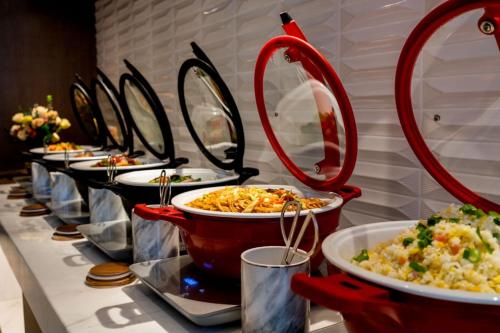 a row of plates of food on a table at Atour Hotel Dalian Development Zone in Dalian