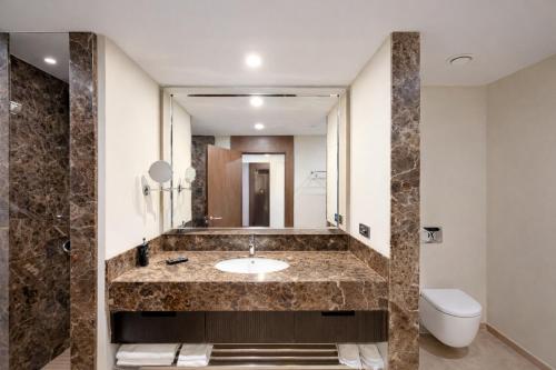 a bathroom with a sink and a mirror at Prime Istanbul Residences in Istanbul