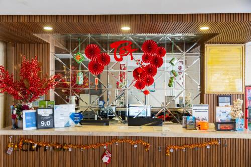 a store with red paper hearts hanging from the ceiling at Gold Central Hotel by Haviland in Danang