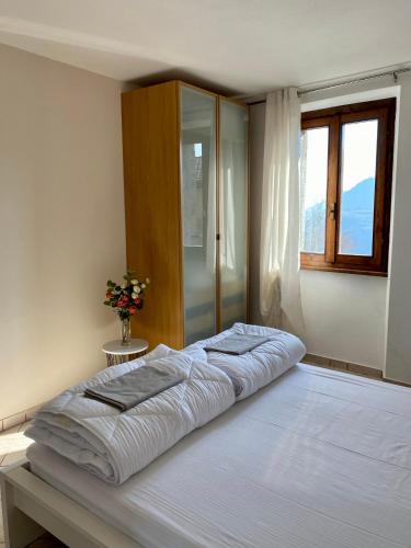 a large bed in a bedroom with a window at Casa Piccola in Tremosine Sul Garda