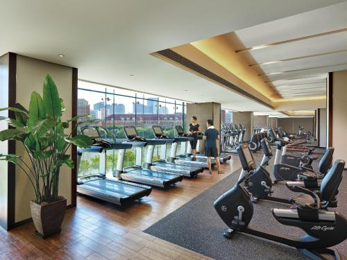 a gym with rows of treadmills and exercise bikes at Shangri-La Tianjin in Tianjin