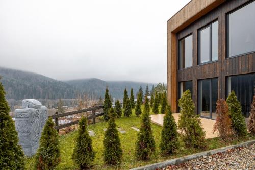 a building with a bunch of trees in front of it at Agate Resort & SPA in Mykulychyn