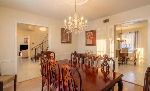 a dining room with a table and a chandelier at Spacious 4BR with Private Pool, Near Six Flags in San Antonio