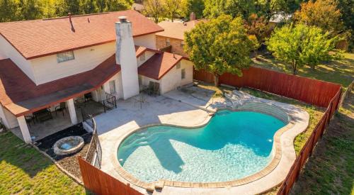an overhead view of a swimming pool in front of a house at Spacious 4BR with Private Pool, Near Six Flags in San Antonio
