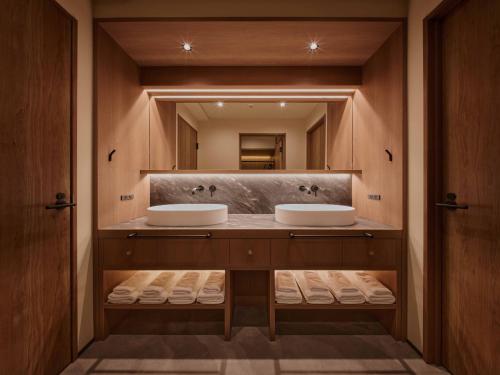 a bathroom with two sinks and a mirror at illi Aest Shinagawa-Gotanda in Tokyo