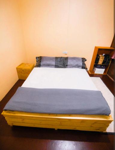 a bed in a room with a blue blanket at New Star House in Arusha