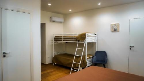 a small room with a bunk bed and a table at Al Duomo Suites in Monreale