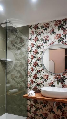 a bathroom with a sink and a mirror at Al Duomo Suites in Monreale