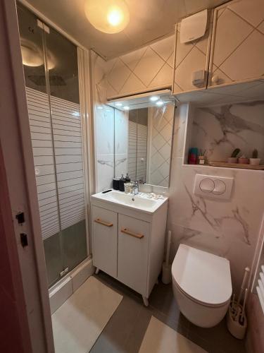a white bathroom with a toilet and a sink at L'Interdite House - Limitless - Jacuzzi Cinema Love in Savigny-sur-Orge