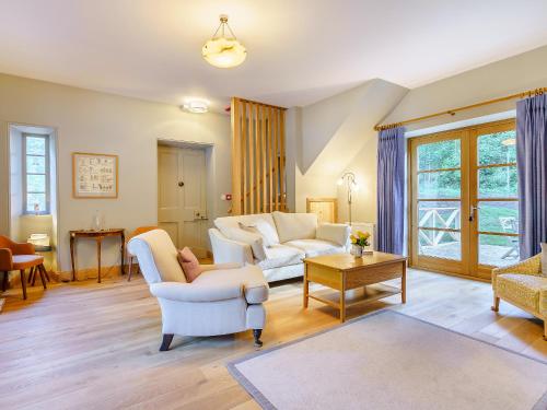 a living room with two white couches and a table at East Lodge in Falkland