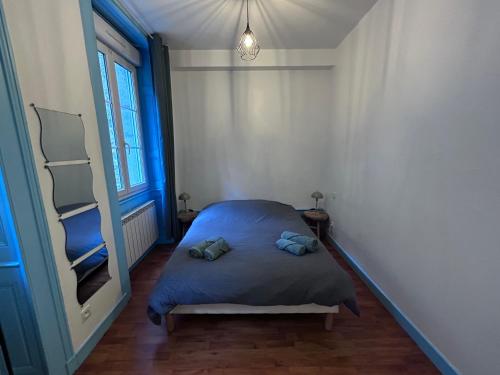 a small bedroom with a bed and a mirror at L azur Jurassien séjour chaleureux dans le Jura in Saint-Claude