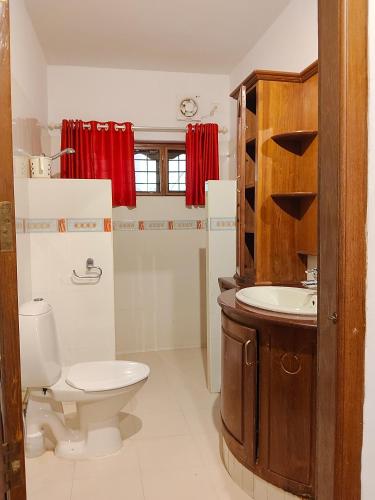 a bathroom with a toilet and a sink at Mansion Du Lac in Kottayam