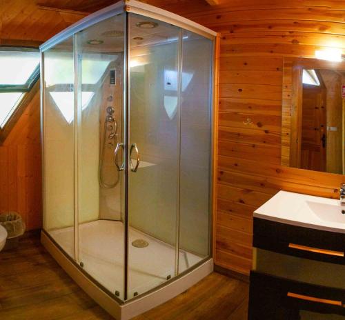 a glass shower in a bathroom with a sink at Camping Las Nogueras de Nerpio in Nerpio